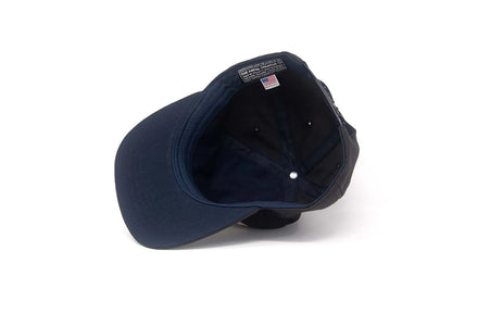 Interior view of the Good Luck snapback hat showing navy lining, Ampal Creative label, and made in USA tag.