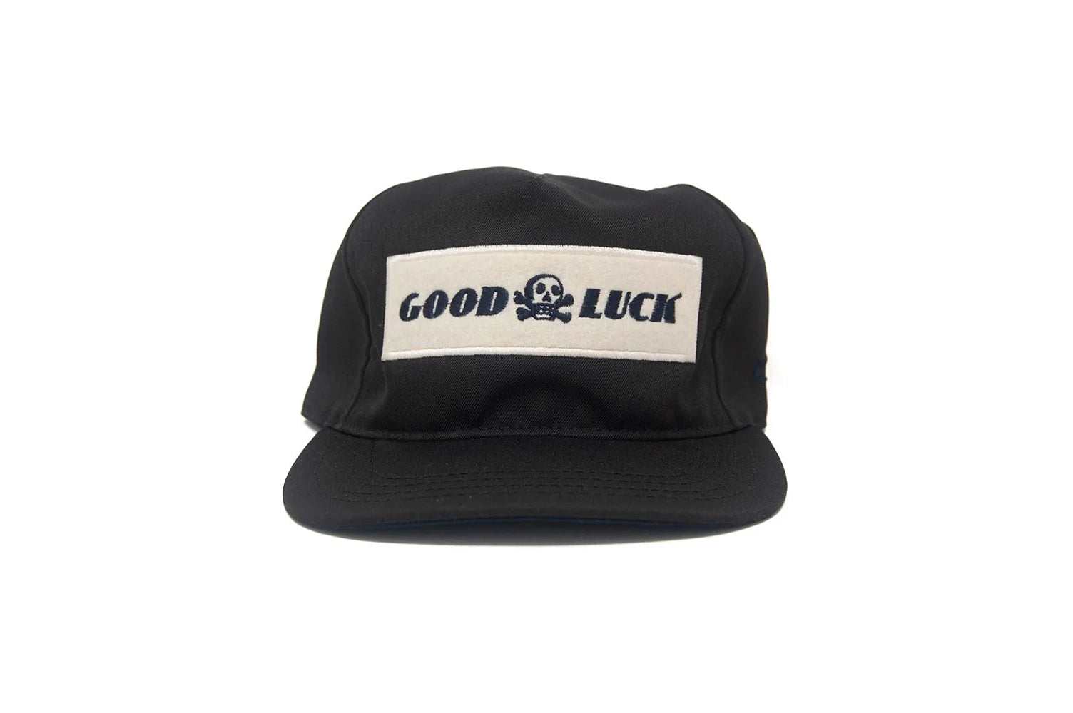 Front view of the black Good Luck snapback hat with embroidered felt patch and skull logo, made in the USA.
