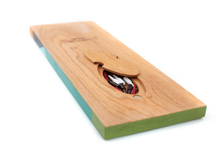 Cherry wood Gooseberry cribbage board showing the rear magnetic storage compartment with red, white, and black pegs.