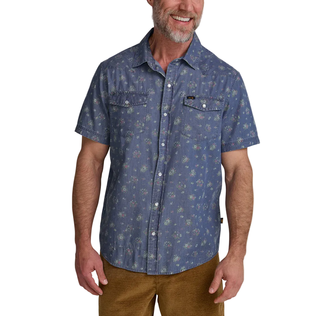 Man wearing Howler Brothers Bouquets Indigo pearl snap shirt front view