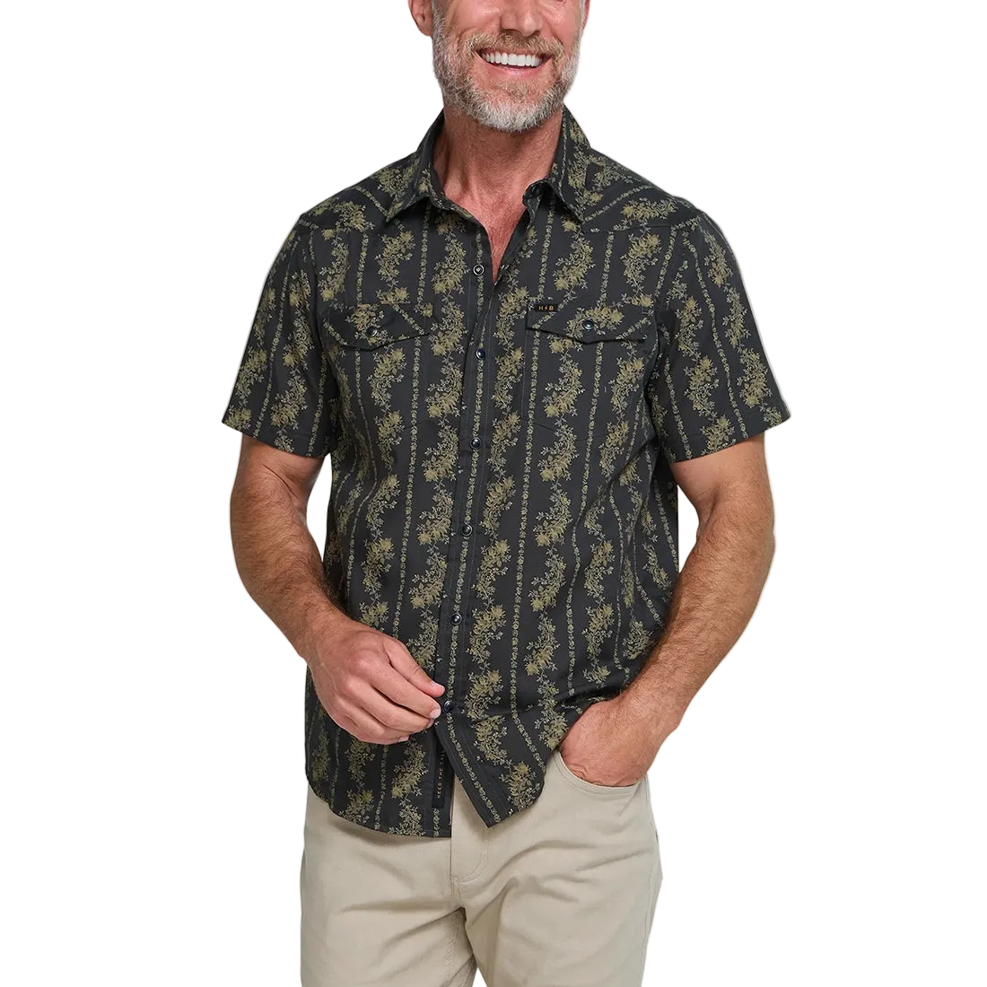 Man smiling wearing the black and olive floral stripe Grampa's Curtains H Bar B Snapshirt, short sleeve western pearl snap shirt, front view -- The Simple Man