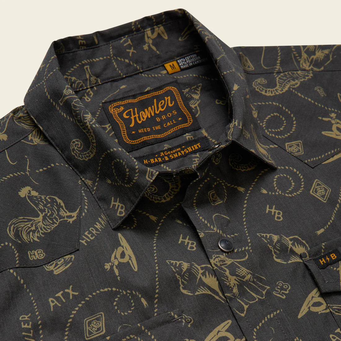 Howler Bros H Bar B Snapshirt collar and snap detail close-up – Sea Rodeo print pearl snaps western yoke Howler Bros Heed the Call label