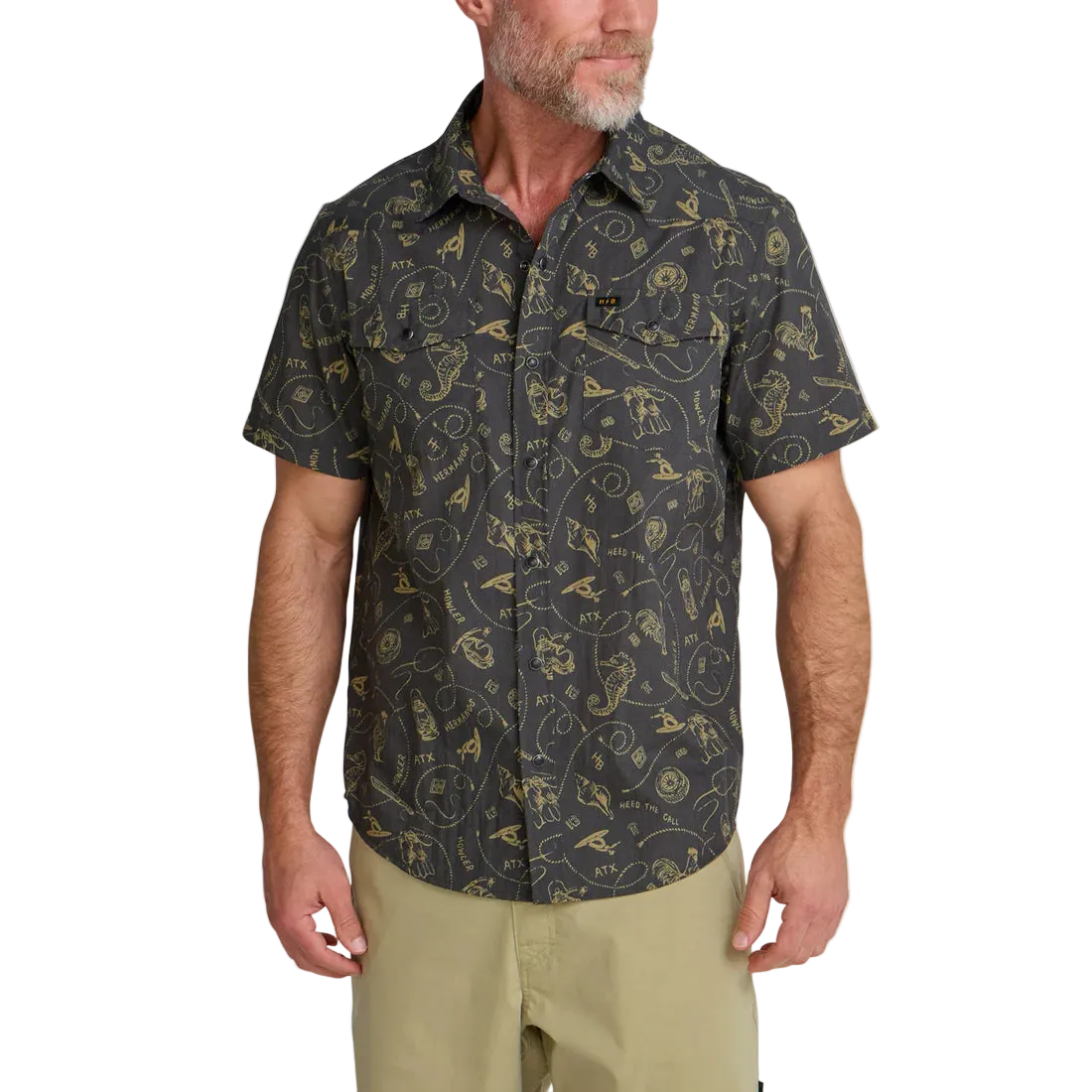 Man wearing Howler Bros H Bar B Snapshirt Sea Rodeo front view – gold on charcoal all-over print western snap shirt regular fit with chinos
