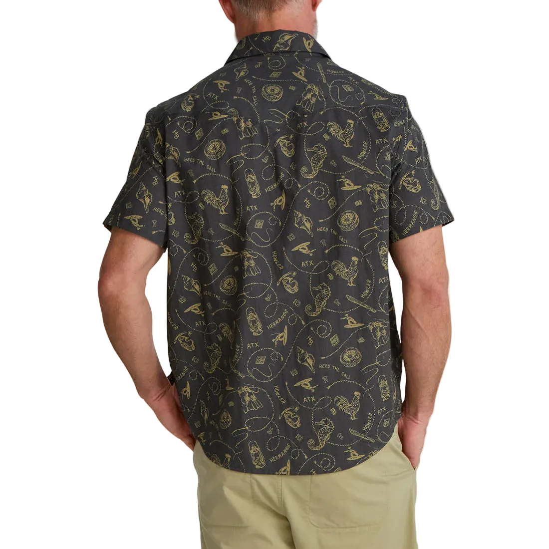 Man wearing Howler Bros H Bar B Snapshirt in Sea Rodeo print back view – charcoal gold western pearl snap short sleeve shirt with chinos