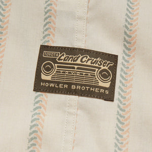 Close-up of Toyota Land Cruiser x Howler Brothers shirt tag on collaborative H Bar B Snapshirt with vintage-inspired stripes