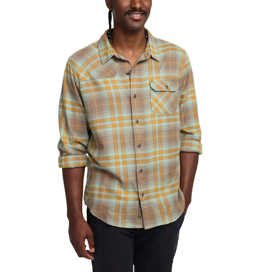 Front view of Howler Brothers Harker’s Flannel in Taupe plaid worn by model, showing chest pocket and rolled sleeves for casual style
