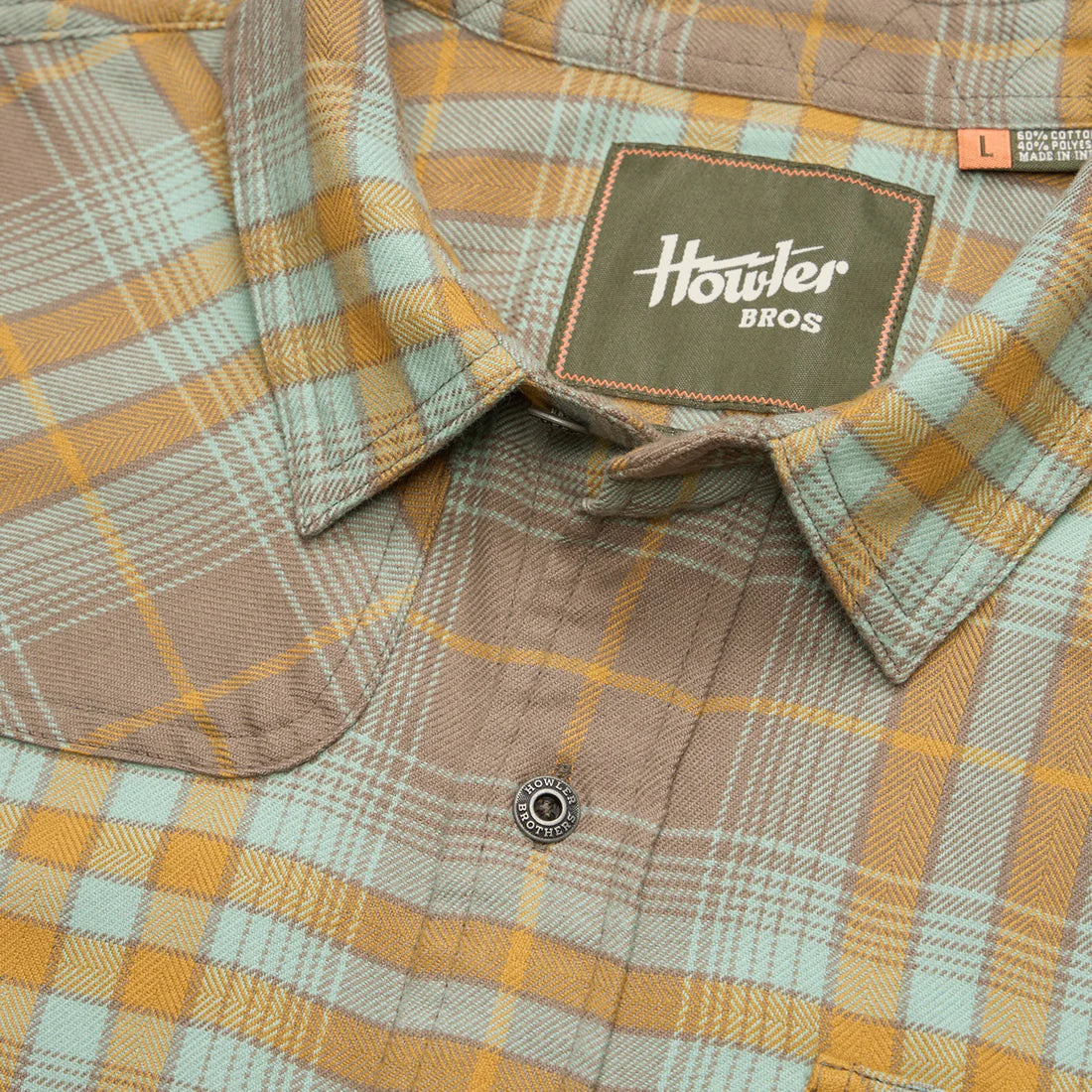 Close-up of Howler Brothers Harker’s Flannel in Kempton Plaid Taupe showing collar detail, soft brushed fabric, and branded label