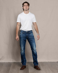 Full front view of model wearing Harlan Straight Easy Rider jeans in medium-dark Italian denim.