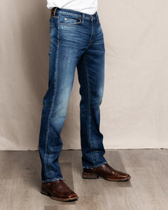 Men’s Harlan Straight Easy Rider jeans in medium-dark wash with natural fading, styled with a white tee and boots