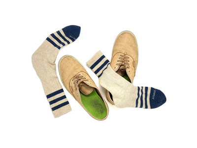 Striped men’s socks in heather oatmeal and navy worn with shoes