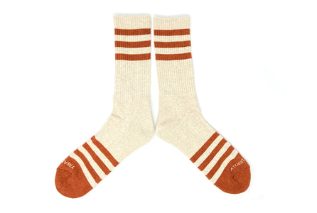 Men’s heather oatmeal socks with orange stripes laid flat