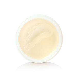 Open jar of cream-colored Heavymade Pomade, top-down detail view
