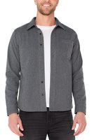 Man wearing men's herringbone cotton button-up shirt in charcoal gray with classic fit, long sleeves, and front chest pocket – The Simple Man