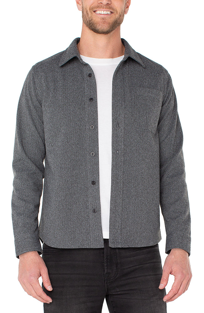 Man wearing men's herringbone cotton button-up shirt in charcoal gray with classic fit, long sleeves, and front chest pocket – The Simple Man