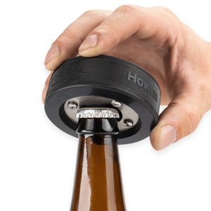 Hockey puck bottle opener, showing use with bottle and a model's hand