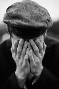 Man wearing Brixton Hooligan herringbone flat cap in black and white lifestyle photo – 1920s inspired snap cap grey black