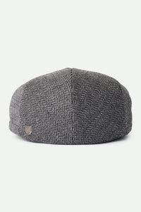 Brixton Hooligan Snap Cap back view on white background – grey black herringbone flat cap with metal crest pin snap closure