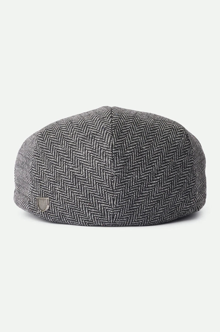 Brixton Hooligan Snap Cap back view on white background – grey black herringbone flat cap with metal crest pin snap closure