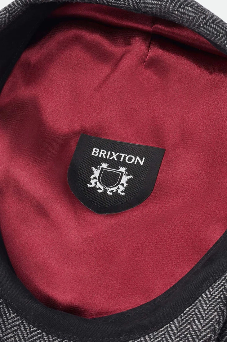 Brixton Hooligan Snap Cap interior close-up – burgundy satin custom liner with Brixton brand label grey black herringbone flat cap