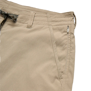 Howler Brothers Horizon Tech Shorts detail – invisible zip pocket, drawcord waistband, and button closure on men's nylon ripstop shorts