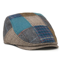 Tradesman patchwork scally cap in blue plaid, teal, gray and tan wool blend, angled view