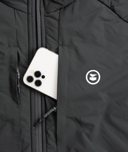 Zippered chest pocket on the Inlet Puffer Jacket holding smartphone – black men’s puffer jacket with secure storage and Oystex insulation