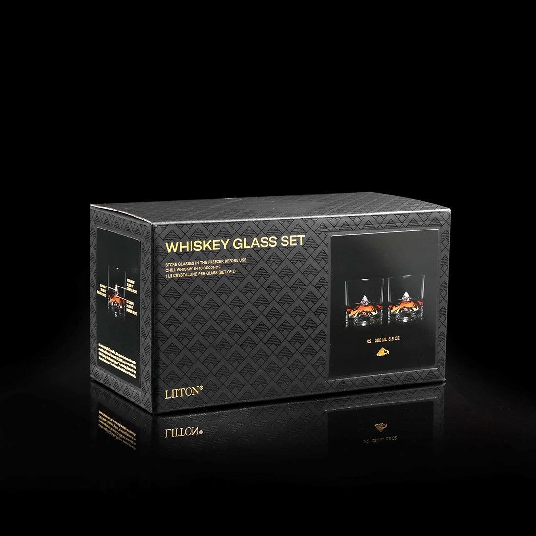 K2 Crystal Mountain Whiskey Glass Set of 2 in black Liiton gift box with gold lettering, shown on reflective black background.
