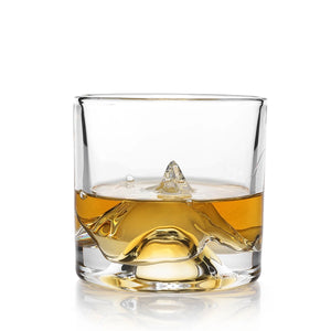 Single K2 Crystal Mountain Whiskey Glass with whiskey poured over raised mountain peak detail on white background.
