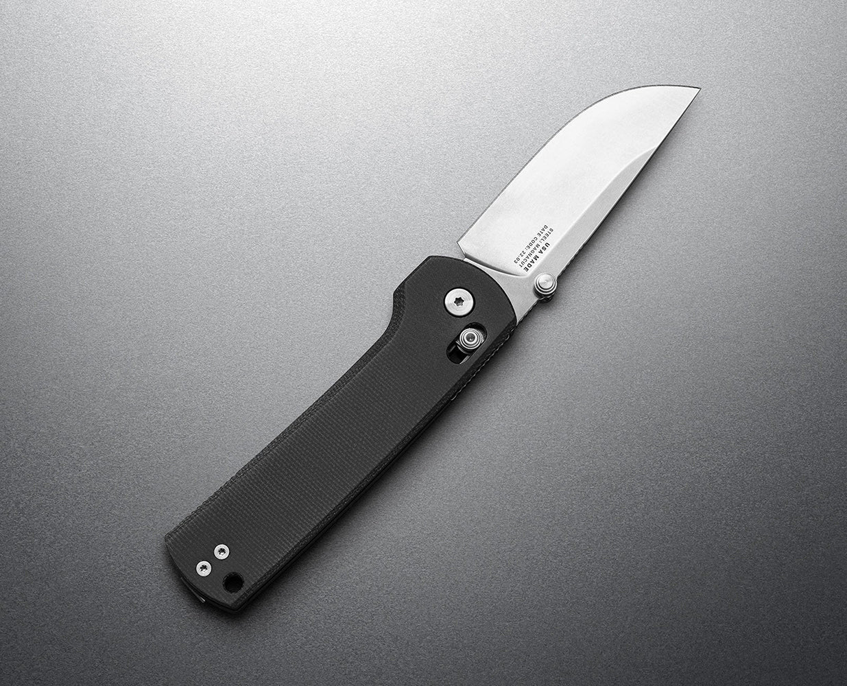 MagnaCut steel folding knife with drop point blade and black Micarta handle, made in the USA