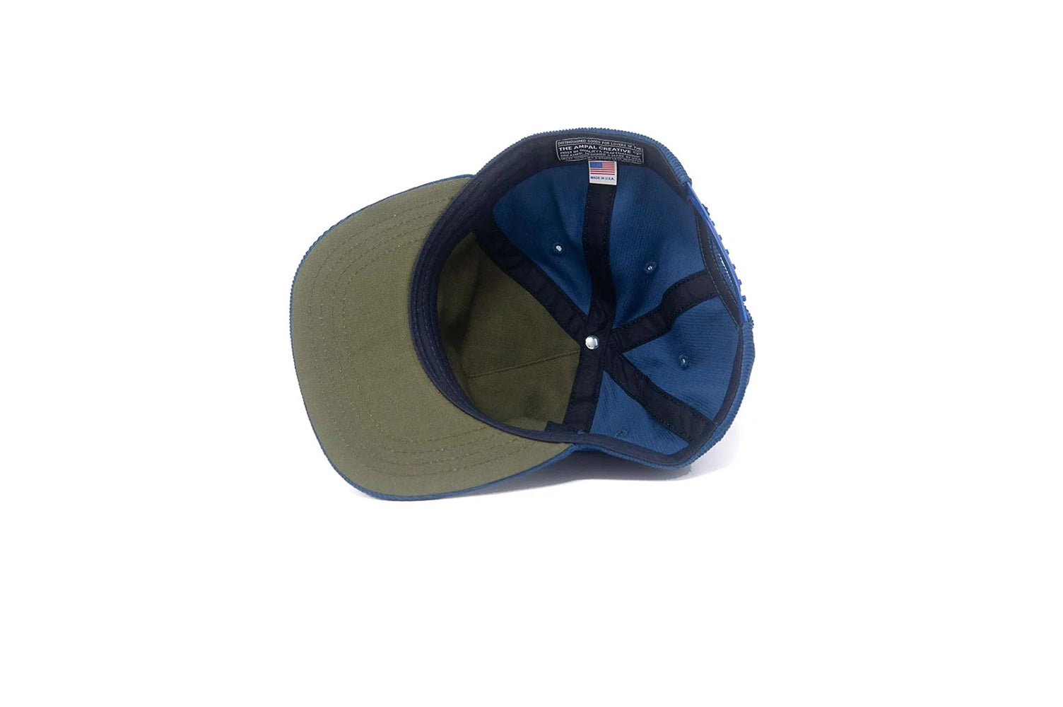 Inside view of the LA City Series snapback showing the olive herringbone underbrim, interior lining, and Made in USA tag