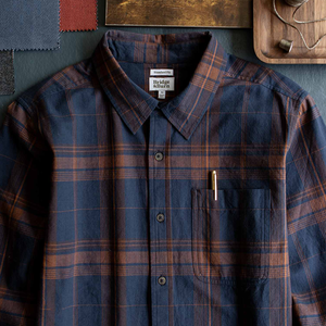 Man wearing Larson Shirt Cinder Plaid open over cream tee outdoors, close-up on navy and rust plaid pattern - The Simple Man