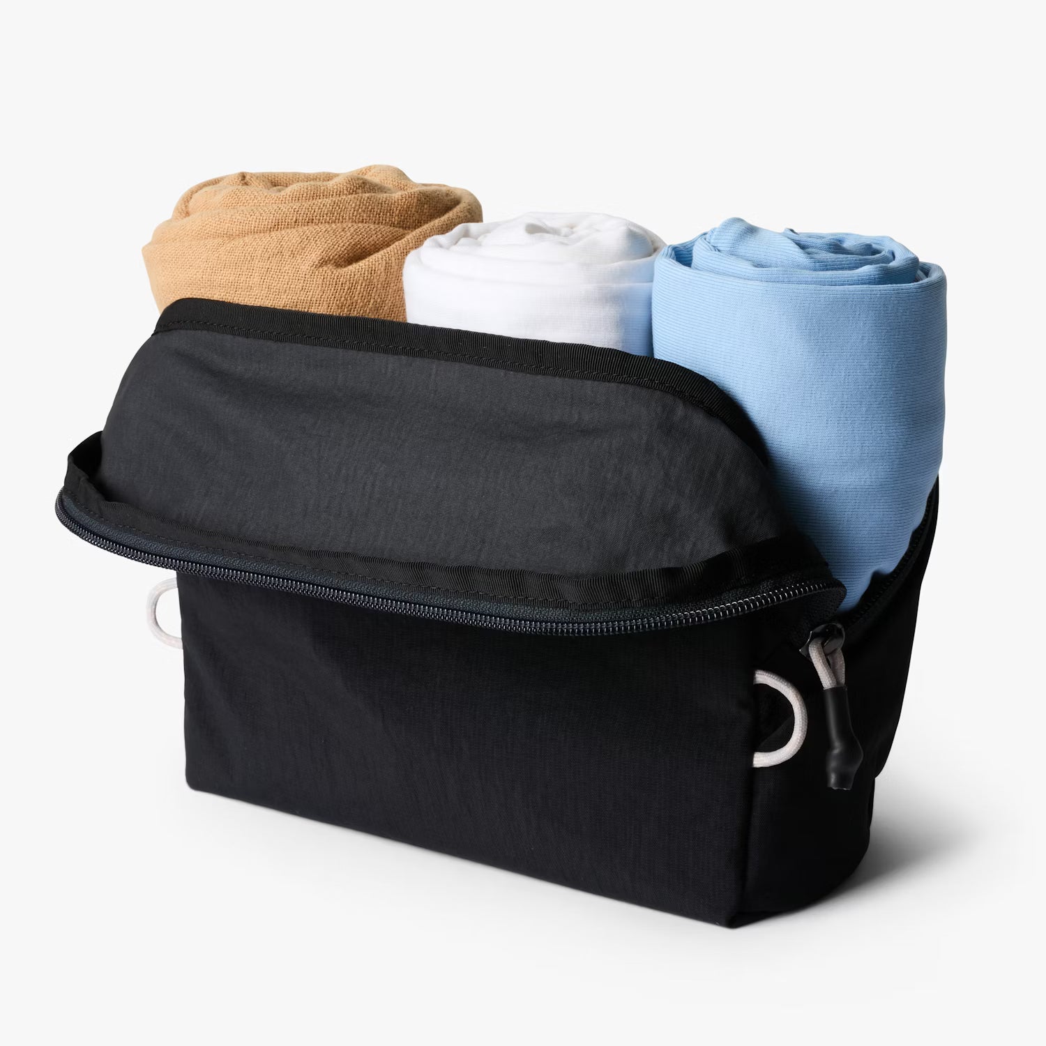 Lite Packing Pouch 3L opened to show interior space for clothing and essentials, lightweight black travel pouch.