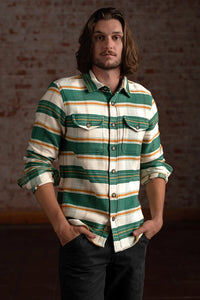 Men’s heavyweight cotton button up shirt with green stripe pattern worn casually