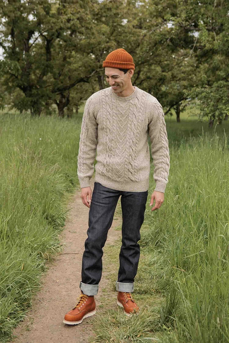 Full-body view of model in The Ludlow Sweater by Bridge & Burn paired with dark denim and leather boots from The Simple Man.