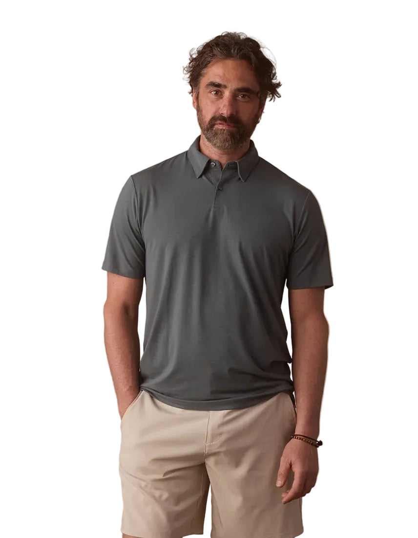 he Normal Brand LuxeJersey Polo Mediterranean Green – front view on model showing hidden button-down collar and engraved placket detail