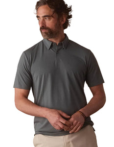 The Normal Brand LuxeJersey Polo Mediterranean Green – front three-quarter view on model wearing men's stretch performance polo shirt