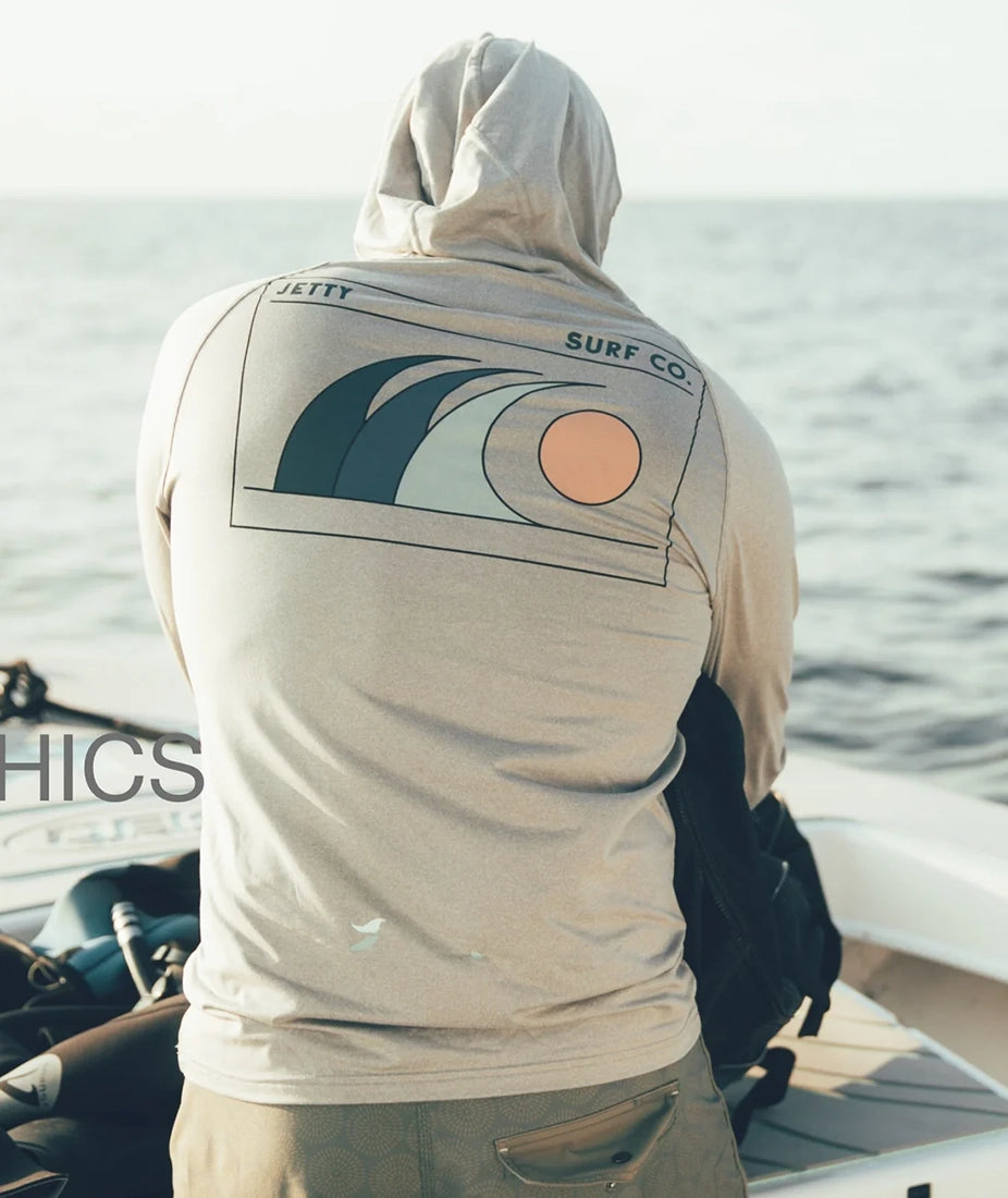 Mahi UV Tech Hoodie Grey lifestyle on boat – UPF 50+ performance hoodie with Jetty Surf Co wave graphic – The Simple Man