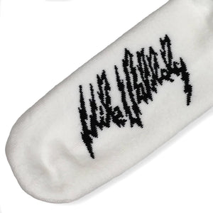 Close up of Mike Vallely signature logo on white sock