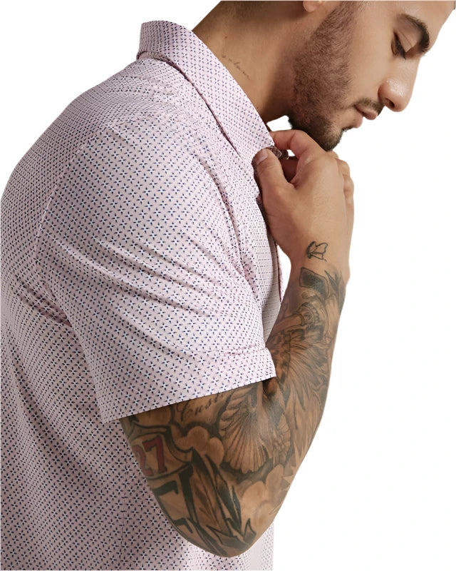 Model wearing 7 Diamonds Marquez Polo in the coral colorway, side close up fabric detail view