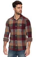 Man wearing a plaid shirt with a white background