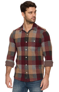 Man wearing a plaid shirt with a white background
