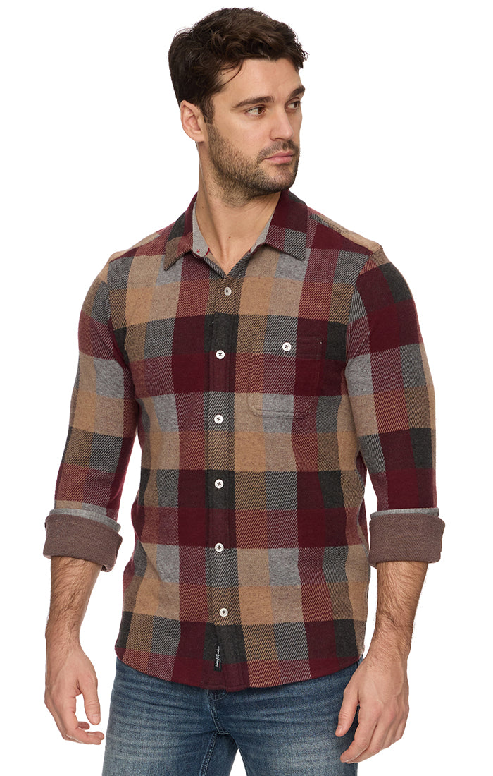 Man wearing a plaid shirt with a white background