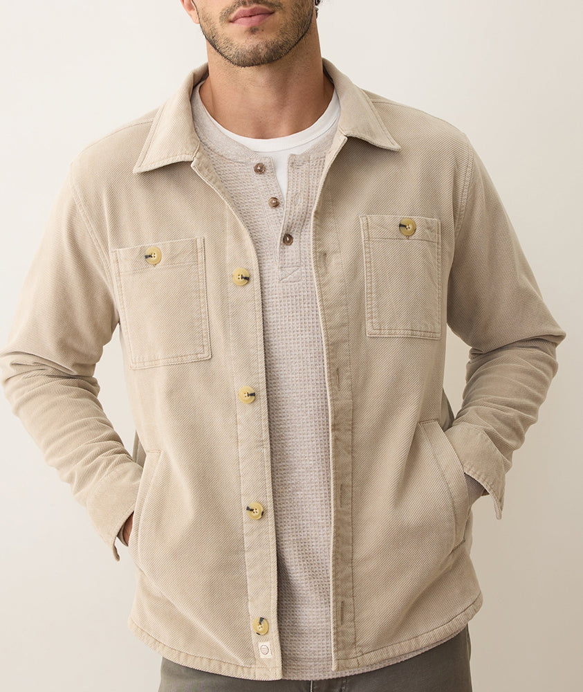 Front view of Max Moleskin Overshirt in taupe with buttoned chest pockets and classic fit, worn over a henley shirt.