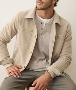 Taupe Max Moleskin Overshirt layered over thermal henley, modeled in seated pose for casual men's fall outfit inspiration.