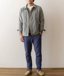 Men wearing slate moleskin overshirt layered over a knit sweater with blue pants