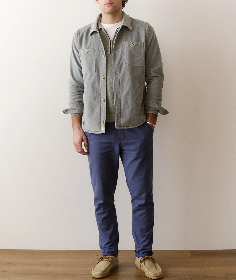 Men wearing slate moleskin overshirt layered over a knit sweater with blue pants