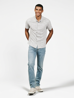 Man wearing Mercer Natural floral print stretch shirt with jeans and sneakers – men's short sleeve button-up 4-way stretch