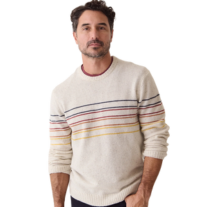 Man wearing the cream Snowhill Sunset Stripe merino crewneck over a maroon tee, front view