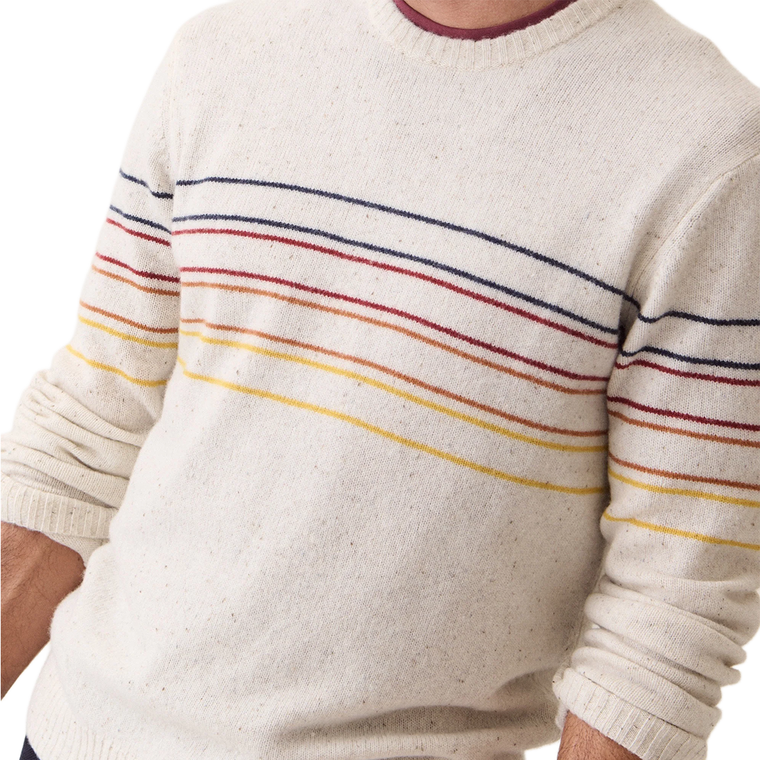 Close-up of the Snowhill Sunset Stripe merino sweater showing fine navy, red, orange and yellow stripes and ribbed neckline