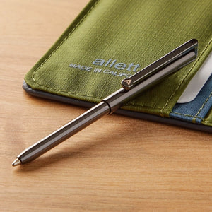 Allett micro pen in gunmetal grey shown next to a wallet